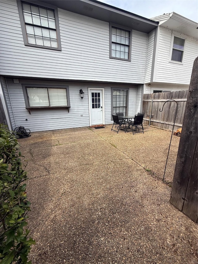 back of house with a patio area and fence