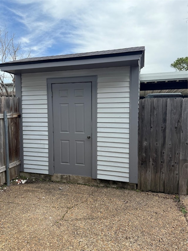 view of shed with fence