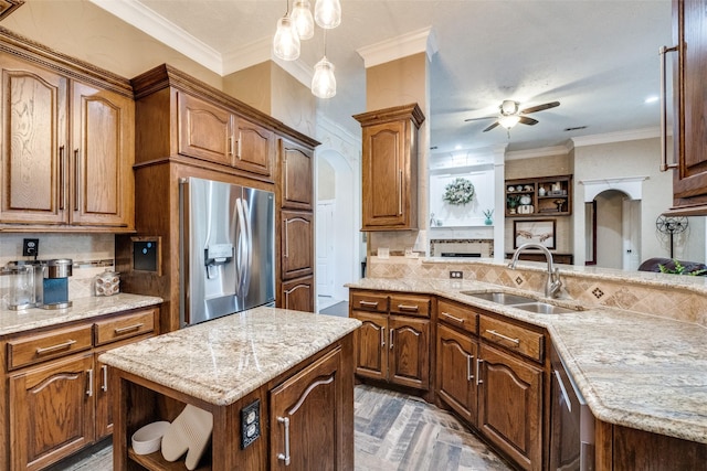 kitchen featuring ornamental molding, open shelves, appliances with stainless steel finishes, and a sink