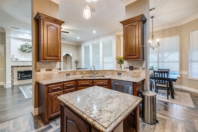 kitchen with tasteful backsplash, visible vents, dishwasher, ornamental molding, and a sink