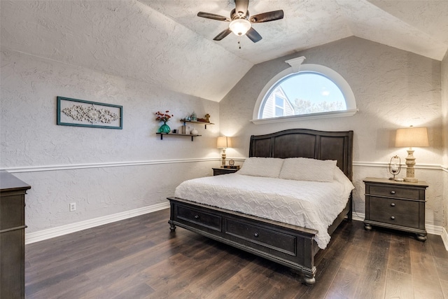 bedroom with baseboards, a textured wall, lofted ceiling, wood finished floors, and a textured ceiling