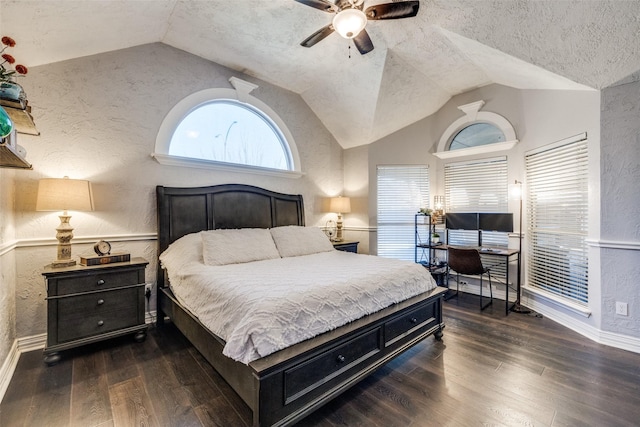 bedroom featuring a textured ceiling, a textured wall, ceiling fan, wood finished floors, and vaulted ceiling