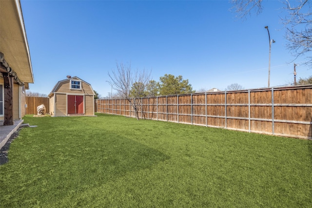 view of yard with a fenced backyard, a shed, and an outdoor structure