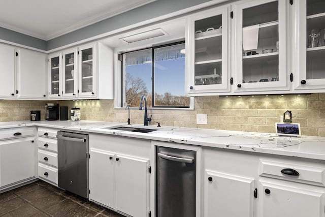 kitchen with a sink, backsplash, white cabinetry, and crown molding