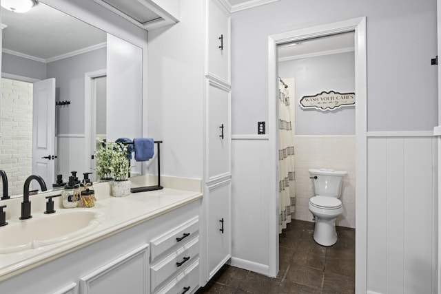 bathroom with toilet, a wainscoted wall, ornamental molding, and vanity