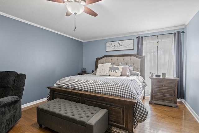 bedroom featuring wood-type flooring, crown molding, and baseboards