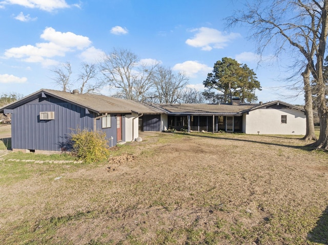 rear view of property featuring crawl space, a lawn, and board and batten siding