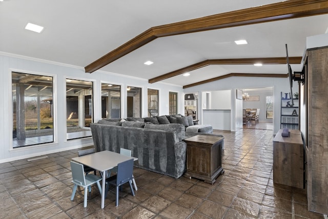 living area with lofted ceiling with beams, ornamental molding, a chandelier, and stone tile floors