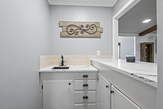 bathroom featuring crown molding and vanity