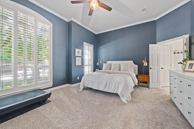 bedroom featuring baseboards, visible vents, ceiling fan, crown molding, and carpet floors