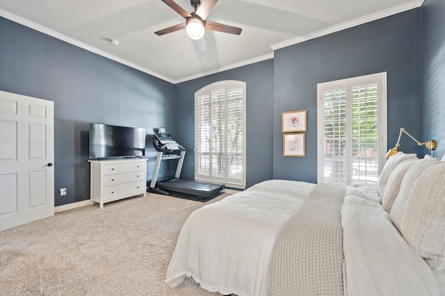 carpeted bedroom with baseboards, ceiling fan, and crown molding