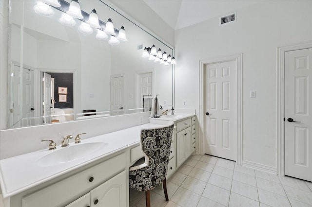 bathroom with double vanity, visible vents, ensuite bathroom, a sink, and tile patterned floors