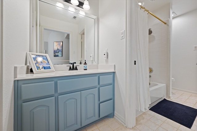 bathroom featuring visible vents, toilet, shower / tub combo, vanity, and baseboards