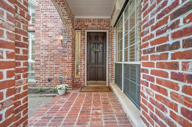 property entrance with brick siding