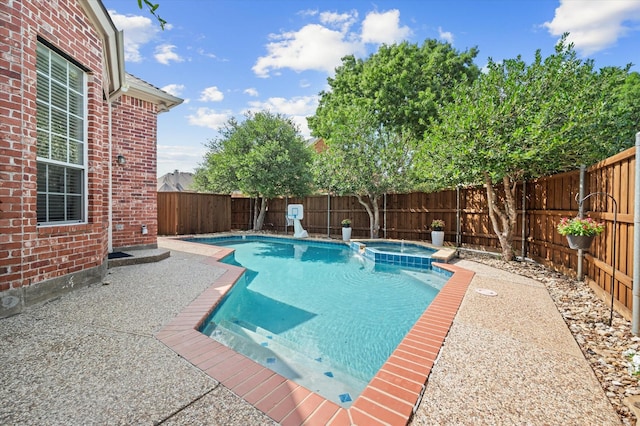 view of pool with a patio area, a fenced backyard, and a pool with connected hot tub