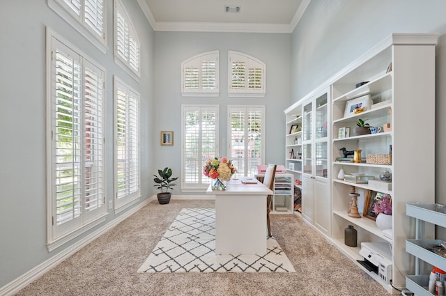 carpeted home office with a towering ceiling, visible vents, and crown molding