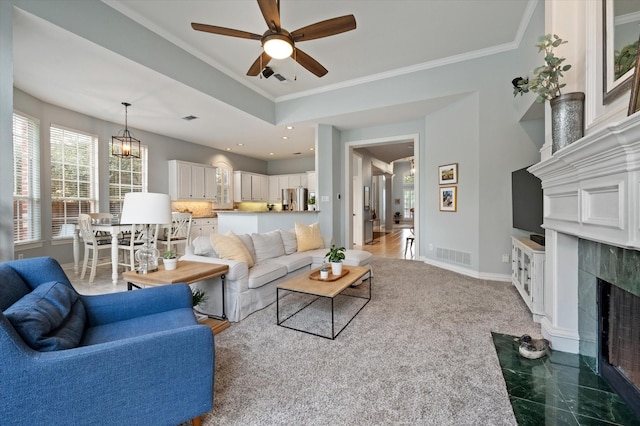 living room with visible vents, ornamental molding, a high end fireplace, and baseboards