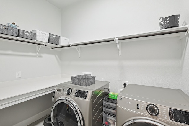 washroom featuring laundry area and washing machine and clothes dryer