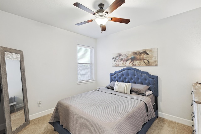 bedroom featuring a ceiling fan, light carpet, and baseboards