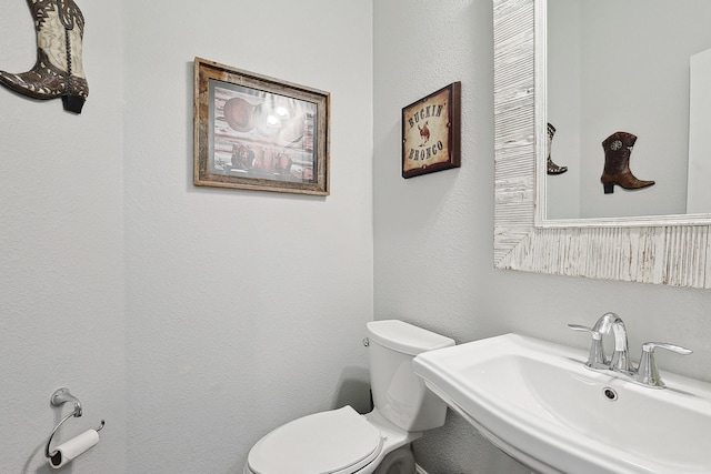 bathroom featuring toilet and a sink