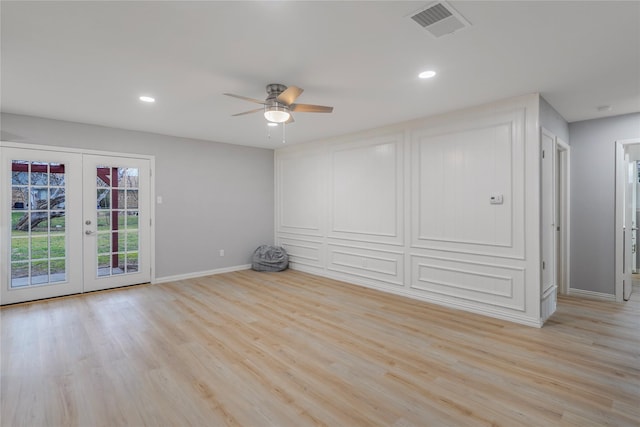 empty room featuring french doors, light wood finished floors, recessed lighting, visible vents, and baseboards