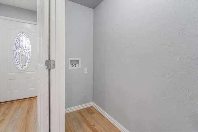 foyer with light wood-type flooring and baseboards