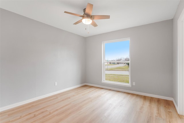 unfurnished room with light wood-style flooring, baseboards, and ceiling fan