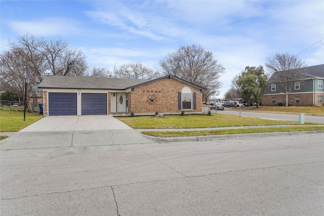 view of front of house with an attached garage, driveway, a front lawn, and brick siding