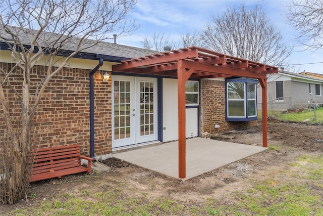 rear view of house featuring a patio, fence, french doors, a pergola, and brick siding