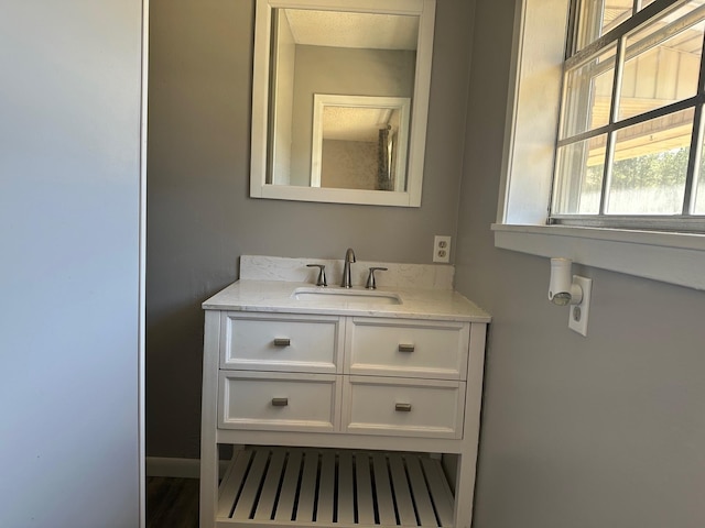 bathroom with vanity and baseboards