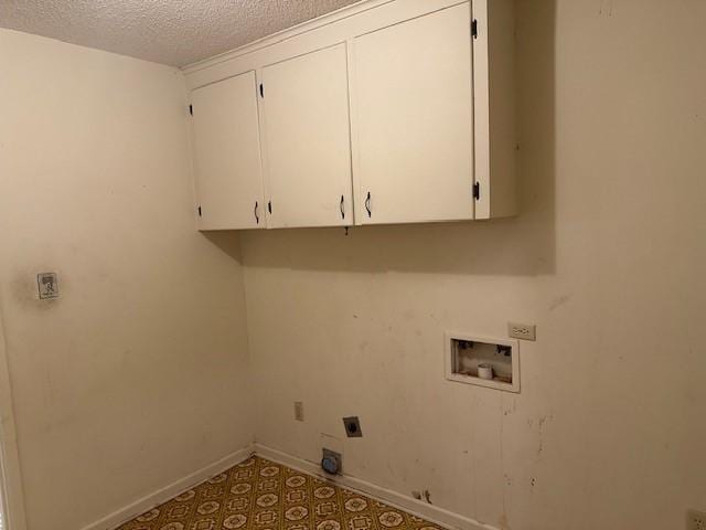 clothes washing area featuring a textured ceiling, hookup for a washing machine, baseboards, cabinet space, and electric dryer hookup