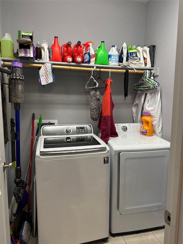 laundry area featuring laundry area, light tile patterned flooring, and washer and dryer