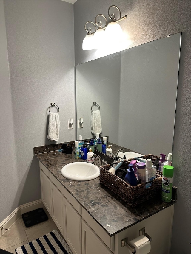 bathroom featuring tile patterned flooring, vanity, and baseboards