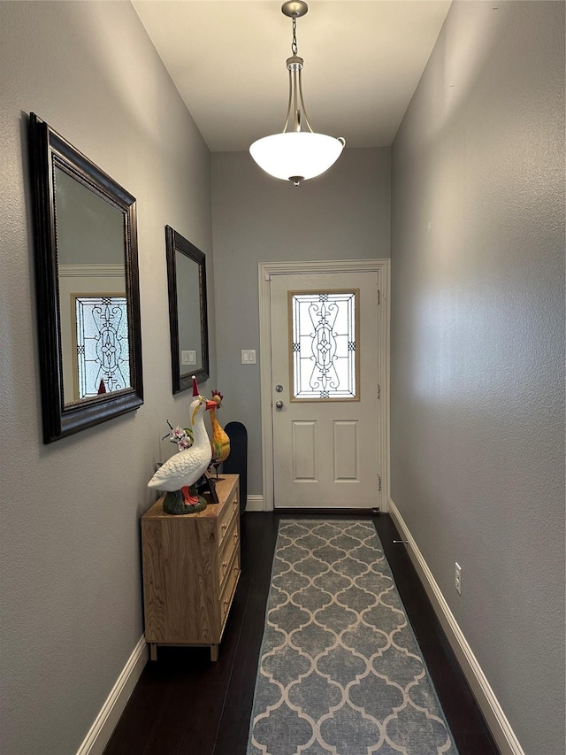 doorway with dark wood-style floors and baseboards