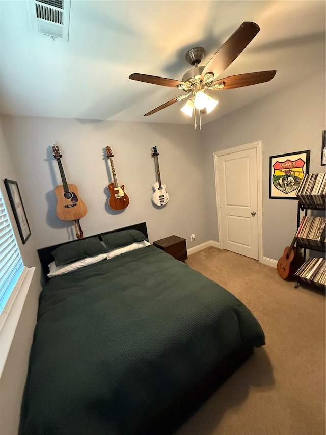 bedroom with a ceiling fan, baseboards, visible vents, and carpet flooring