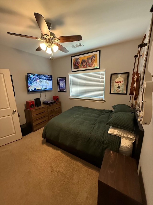 carpeted bedroom with visible vents and ceiling fan