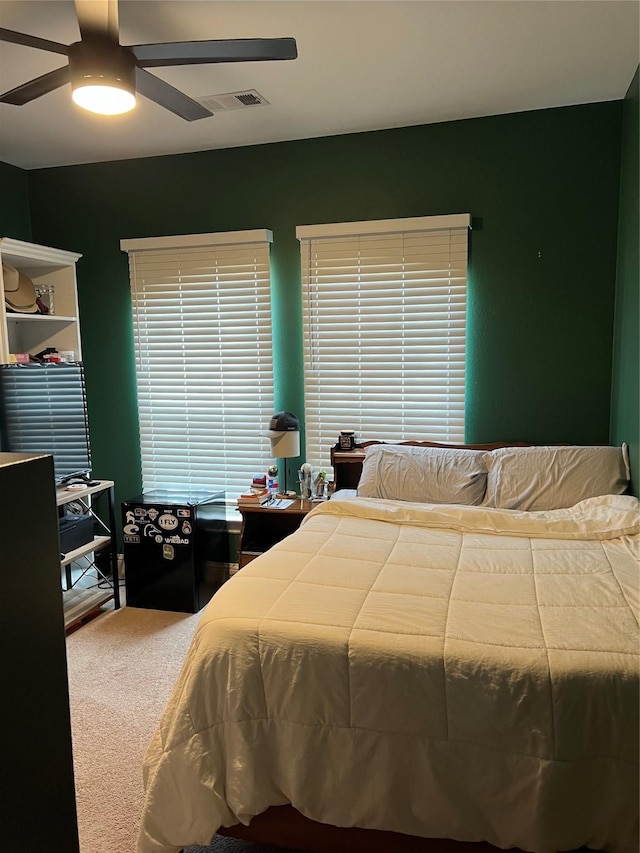 bedroom with a ceiling fan, carpet, and visible vents