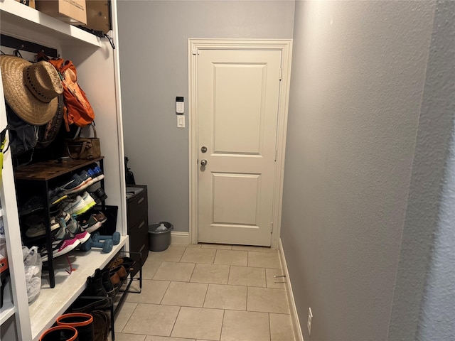 mudroom with baseboards and light tile patterned floors