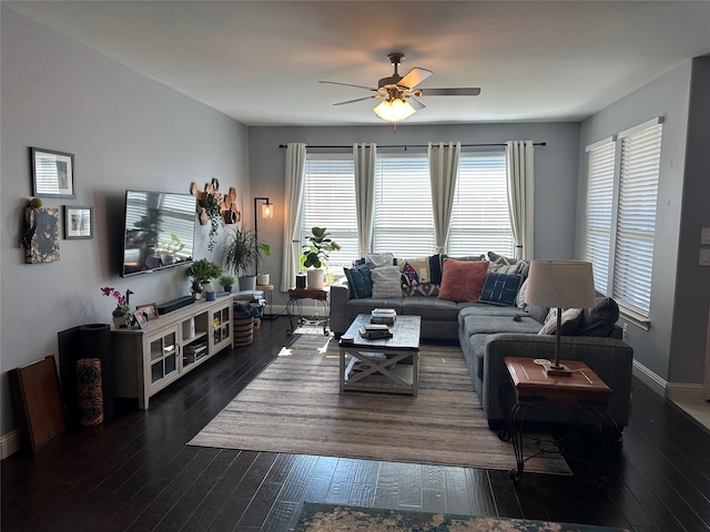 living area with wood-type flooring, baseboards, ceiling fan, and a wealth of natural light