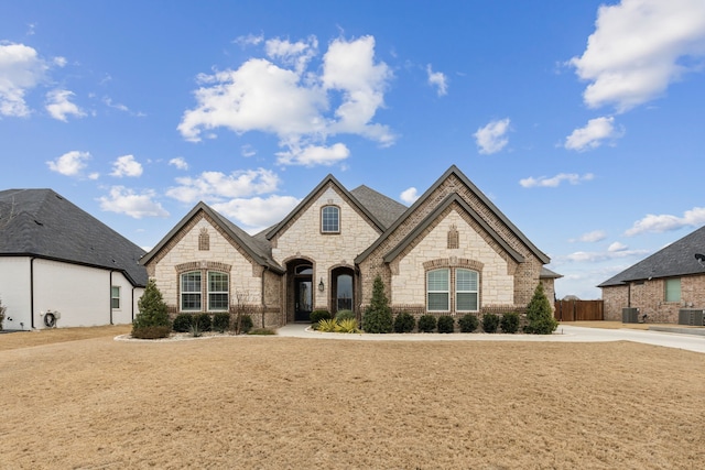 french country home with central air condition unit