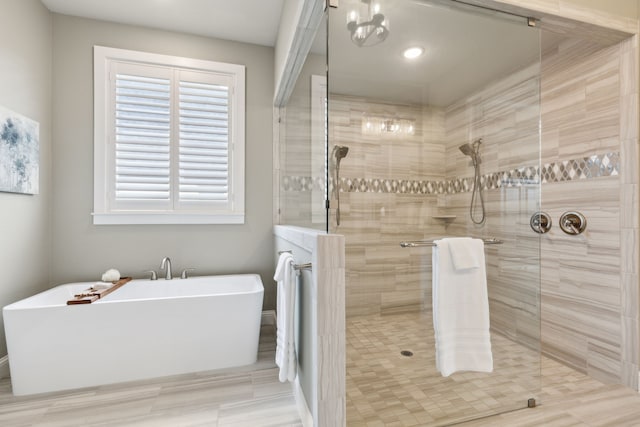 full bath featuring a freestanding tub and walk in shower