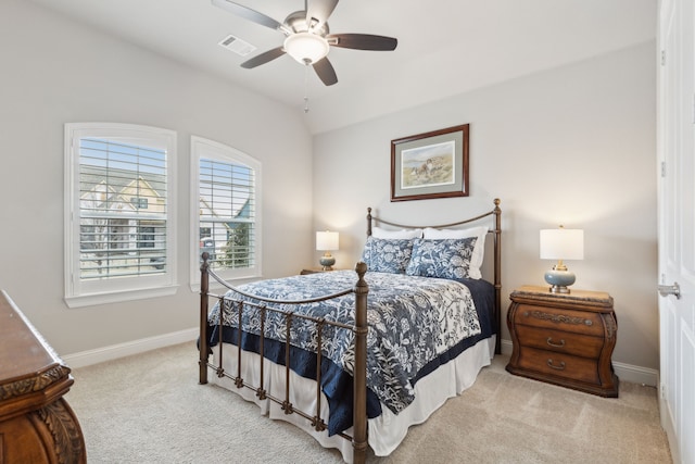 carpeted bedroom with vaulted ceiling, a ceiling fan, visible vents, and baseboards