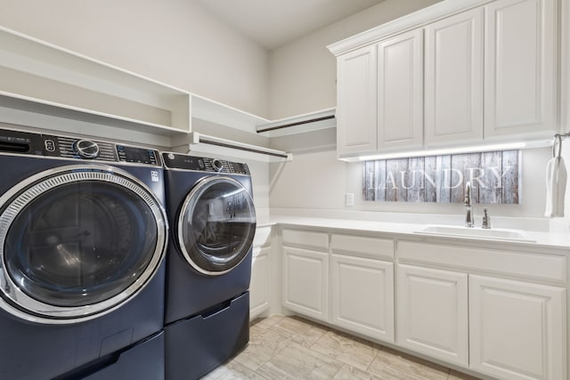 laundry room featuring cabinet space, washer and dryer, and a sink