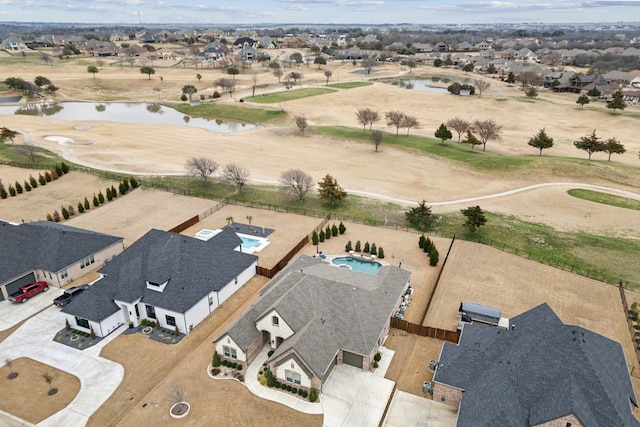 drone / aerial view featuring a residential view and a water view