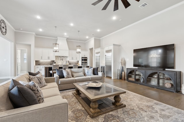 living room with recessed lighting, visible vents, ornamental molding, ceiling fan, and wood finished floors