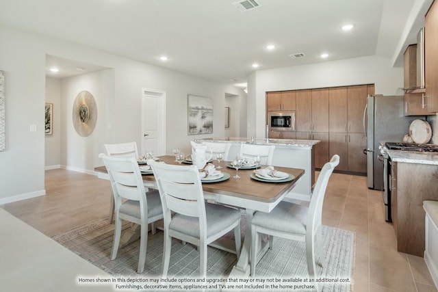 dining area with light tile patterned floors, baseboards, visible vents, and recessed lighting