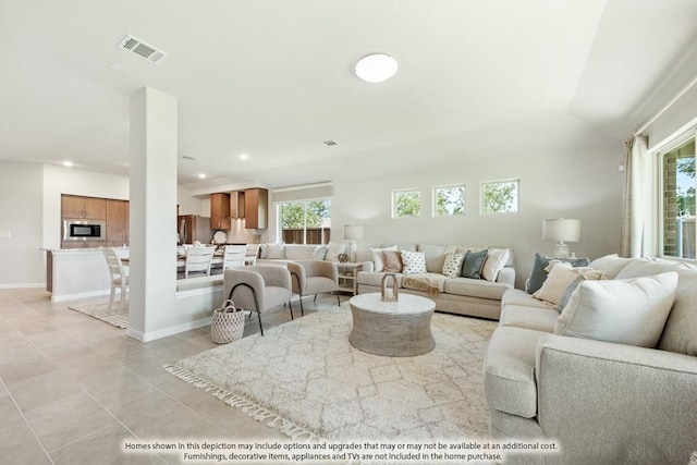 living area featuring light tile patterned floors, baseboards, visible vents, and recessed lighting