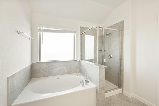 bathroom featuring a shower stall, tile patterned floors, and a garden tub