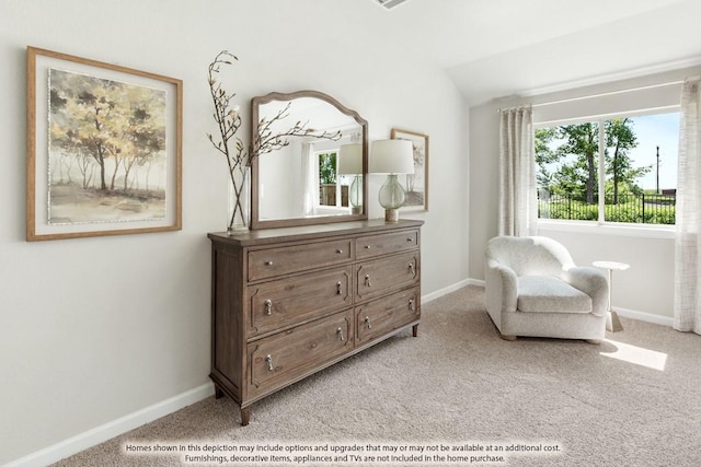 sitting room featuring lofted ceiling, baseboards, and light colored carpet