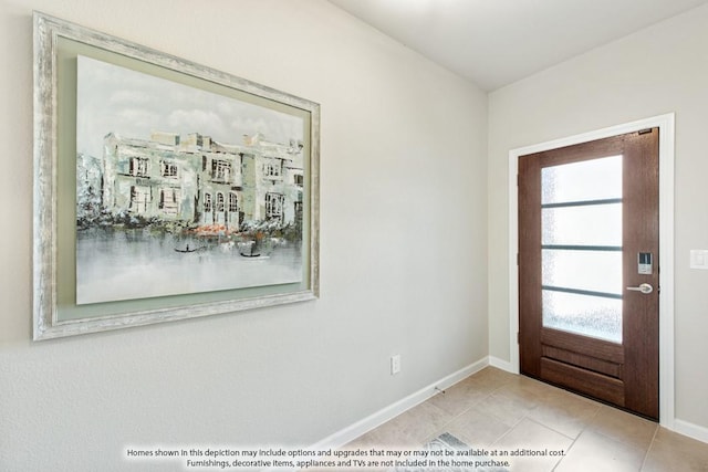 tiled entrance foyer with baseboards